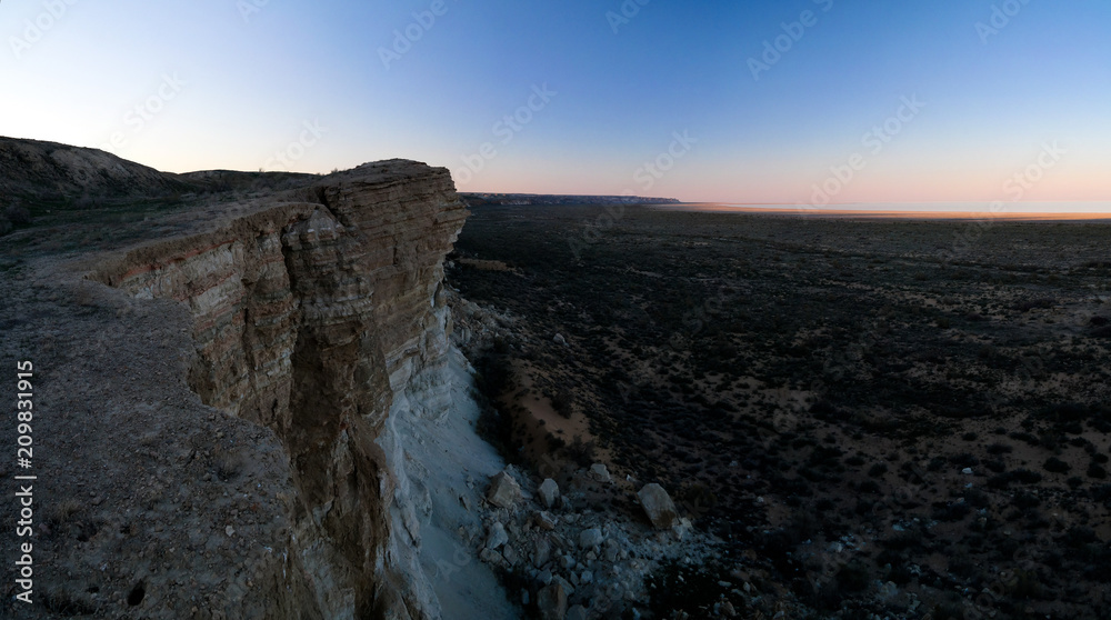 Panorama view to Aral sea from the rim of Plateau Ustyurt near Aktumsuk cape at sunset, Karakalpakstan, Uzbekistan