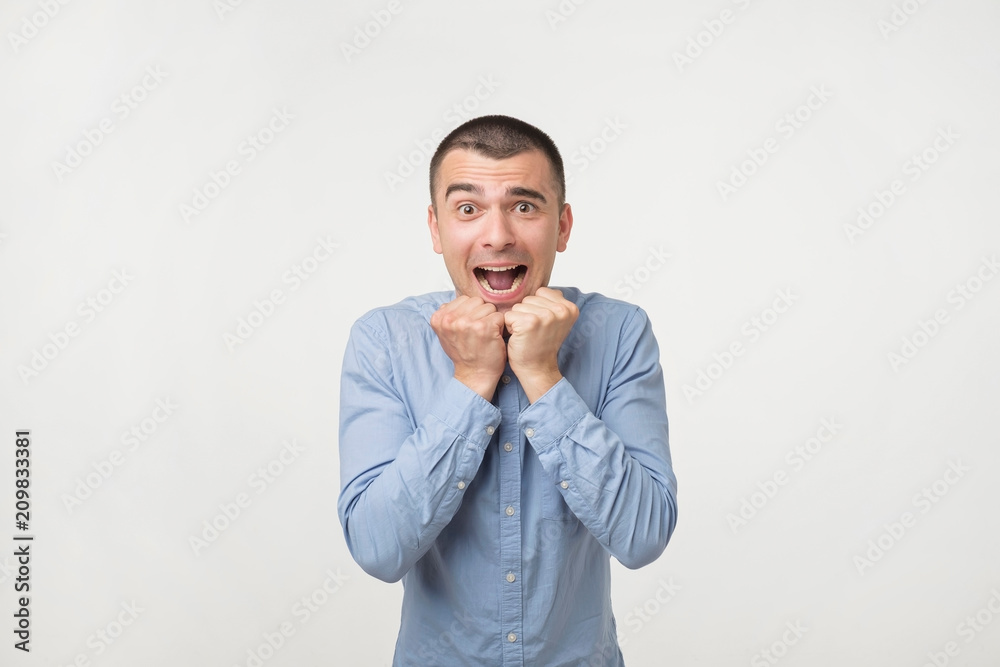 Concept of celebrating victory holding fists in deep emotional expression of happiness. Concept of celebrating victory holding fists in deep emotional expression of happiness.