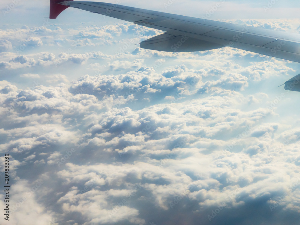 Fototapeta premium Flying above the clouds by the airplane