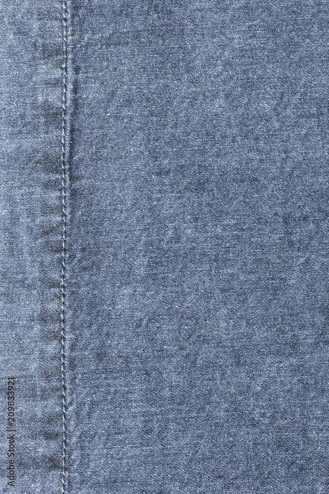 Old blue denim jeans texture or background with visible fibers and stitch Old blue denim jeans texture or background with visible fibers and stitch