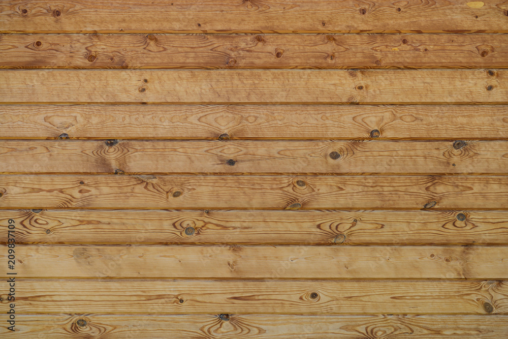 wall of wooden planed logs square section wall of wooden planed logs square section