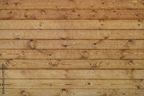 wall of wooden planed logs square section