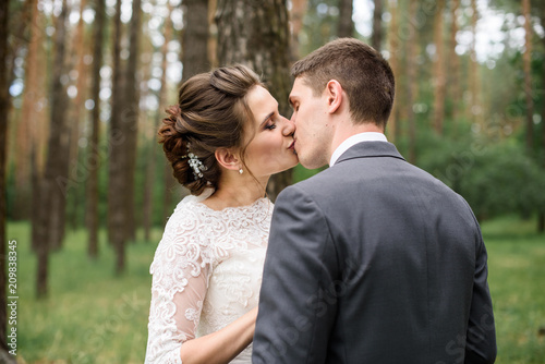 wedding. beautiful couple kissing outdoor © Nestyda
