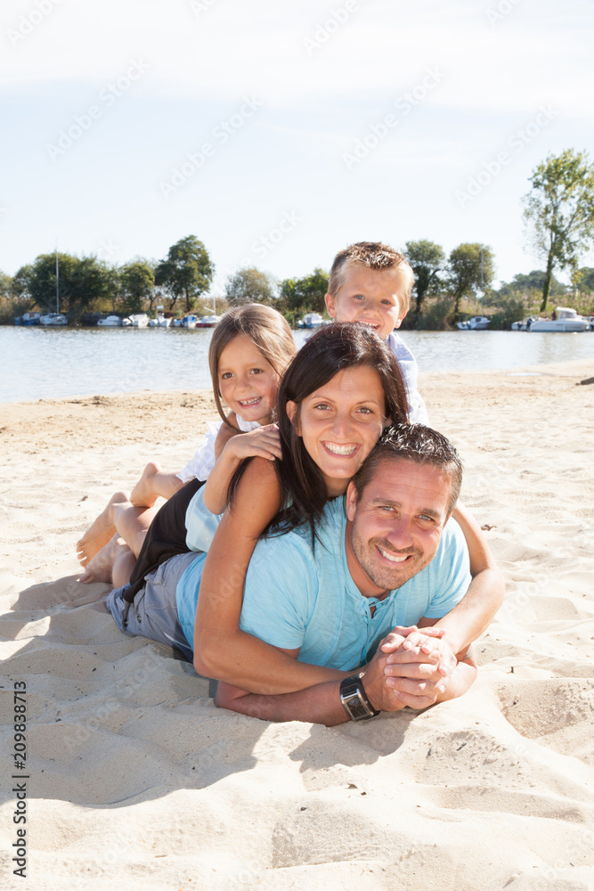 Happy family playing at the beach in Summer vacation concept Happy family playing at the beach in Summer vacation concept