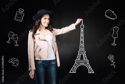Hello Paris. Happy young woman making her dream come true and taking photos with the beautiful Eiffel tower