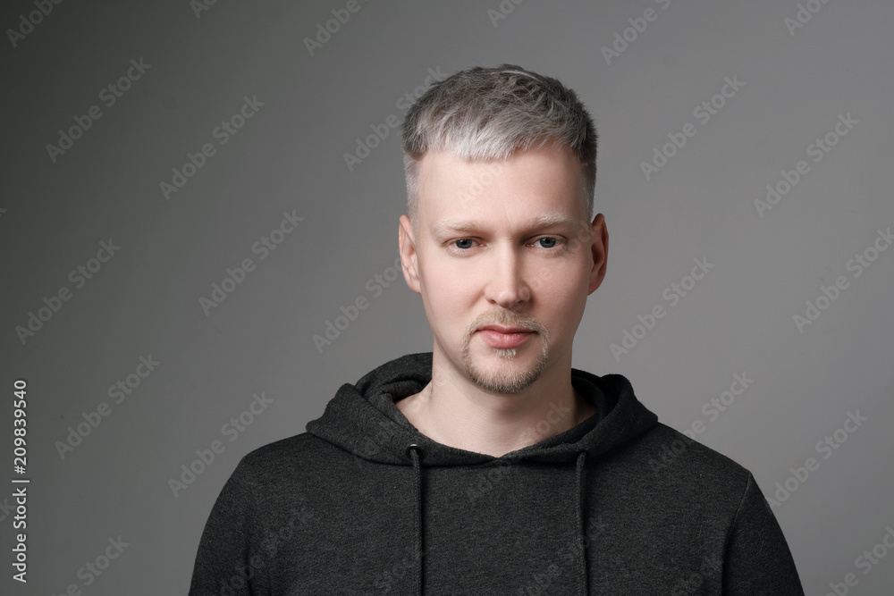 Young man with gray hair in casual clothes on white and gray background.  Portrait in the studio. Creative hair coloring. Stock Photo | Adobe Stock