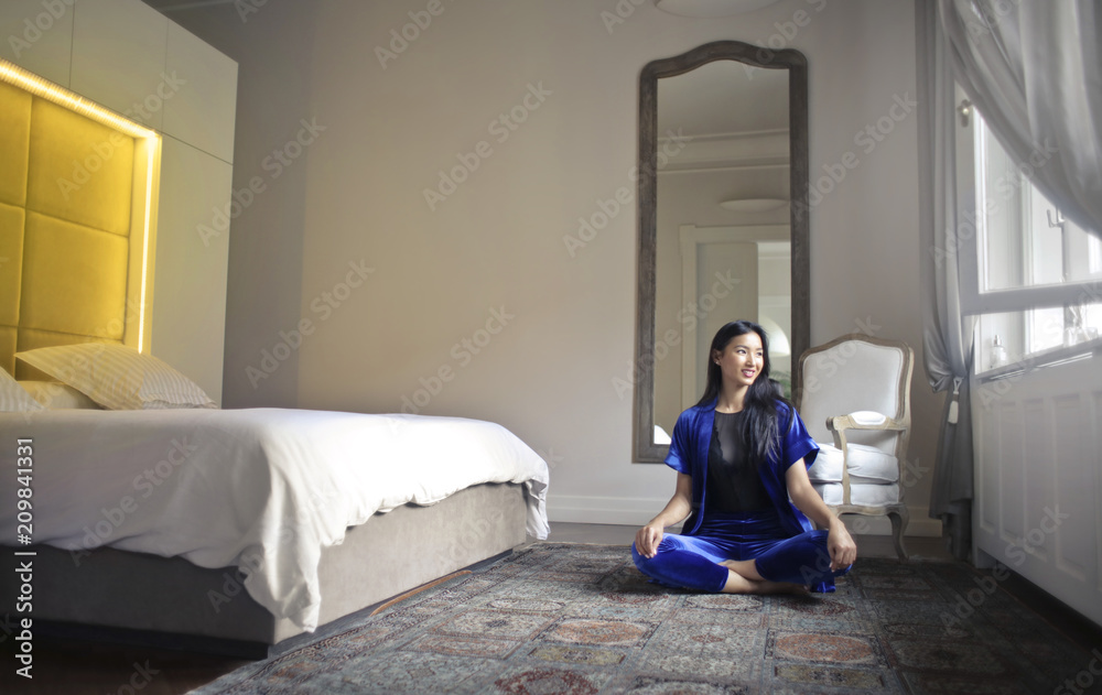 Beautiful woman sitting in her bedroom Beautiful woman sitting in her bedroom