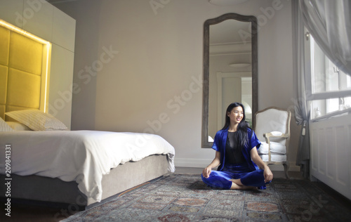 Beautiful woman sitting in her bedroom