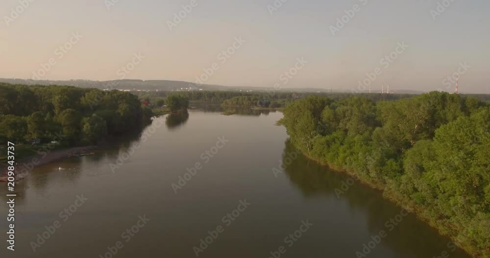 Aerial View. Flying over the beautiful river near small city. Aerial camera shot. Landscape panorama. 4K Aerial View. Flying over the beautiful river near small city. Aerial camera shot. Landscape panorama. 4K