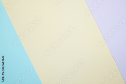 Fashionable pastel colored paper flat lay top view, geometric background texture, pink, purple, yellow, beige, green and blue.