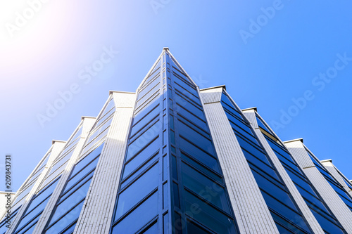 Details of office building exterior. Business buildings skyline looking up with blue sky. Modern architecture apartment. High tech exterior. Reflective buildings. Office Skyscraper. Glass office.