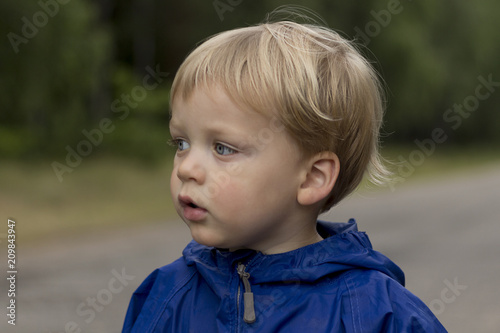 Portrait of thoughtful little boy in the park, adorable toddler in a playing outdoors © Olga