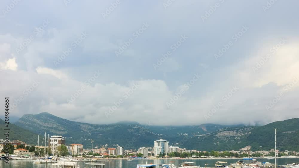 Time lapse, clouds moving over the Budva city and mountains, Adriatic sea coastline in Montenegro Time lapse, clouds moving over the Budva city and mountains, Adriatic sea coastline in Montenegro