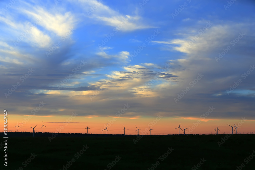 The silhouette of the windmill in the sunset