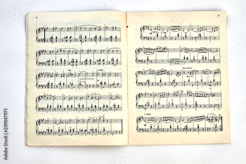 Book with musical notes. A musical book with musical notes on light background, top view. photo