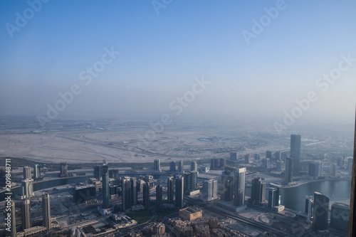 Dubai, United Arab Emirates -November 5, 2015: Aerial view of Downtown Dubai shooting through the glass window from the tallest building in the world , Burj Khalifa.