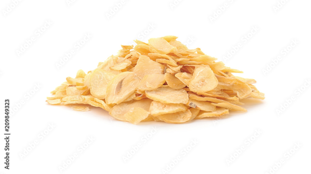 Pile of dried garlic flakes on white background