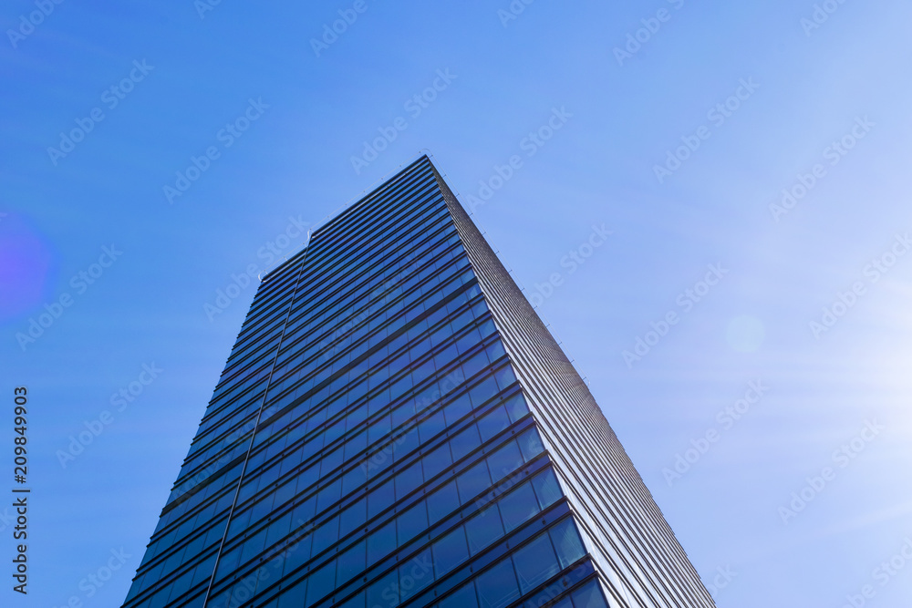 Details of office building exterior. Business buildings skyline looking up with blue sky. Modern architecture apartment. High tech exterior. Reflective buildings. Office Skyscraper. Glass office.