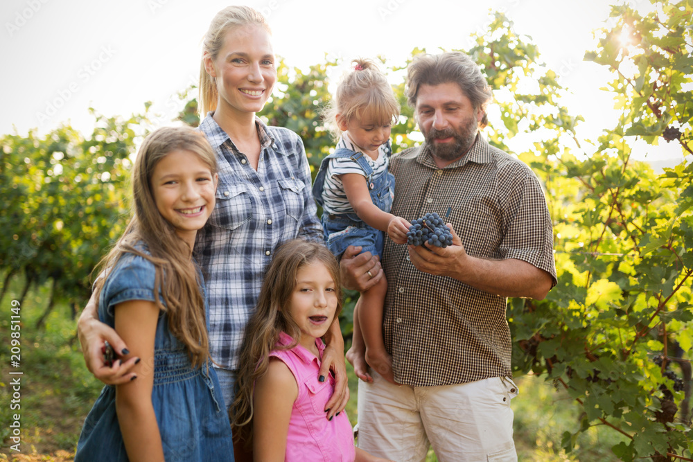 Fototapeta premium Winemaker family together in vineyard
