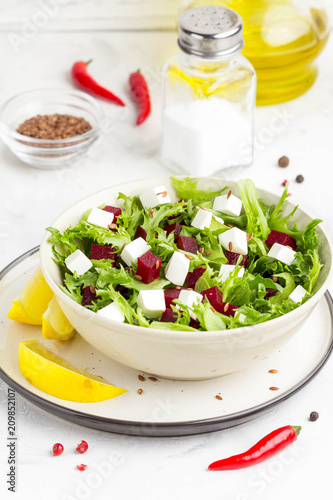 Salad with lettuce, boiled beets, feta cheese, flax seeds and lemon