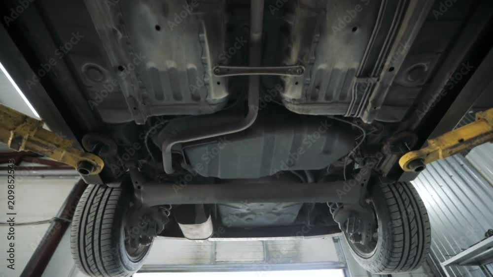 The bottom of the car. Garage service. Automobile diagnostic The bottom of the car. Garage service. Automobile diagnostic
