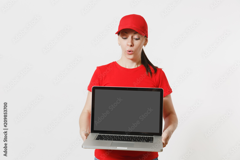 Delivery concept. Woman in red cap, t-shirt isolated on white background. Professional caucasian female working as courier holding pc computer with blank empty screen to copy space for advertisement. Delivery concept. Woman in red cap, t-shirt isolated on white background. Professional caucasian female working as courier holding pc computer with blank empty screen to copy space for advertisement.