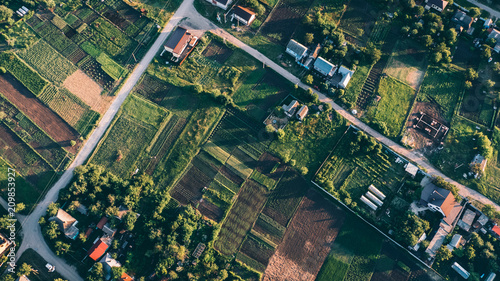 Top view, aerial photo from drone or aerostat to countryside with houses, roads, meadows and green fields