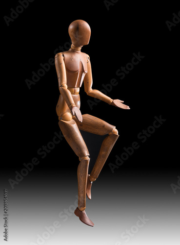 wooden mannequin jumping on a black and white gradient background, vertical © Corinto
