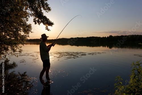 Fisherman catching the fish during sunset