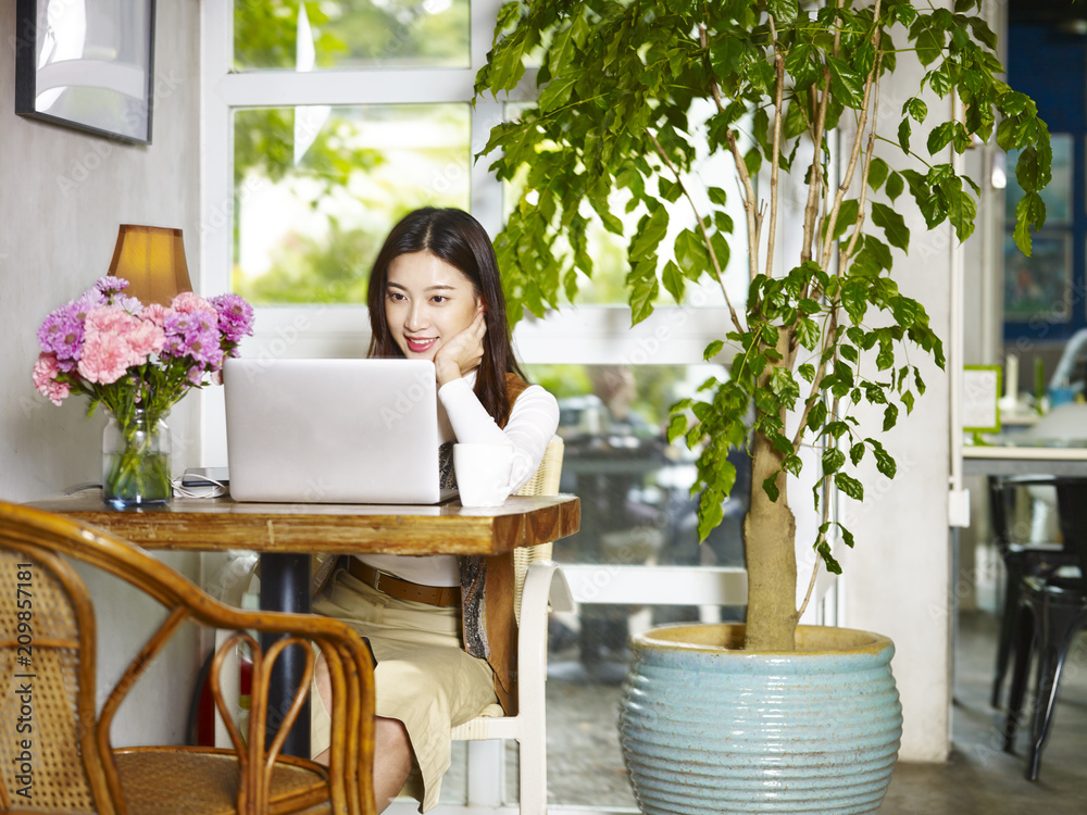 young woman using working with laptop in coffee shop young woman using working with laptop in coffee shop