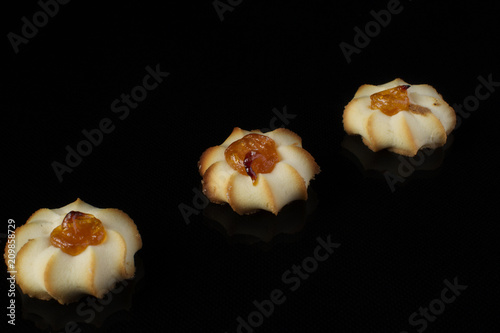 Shortbread cookie with jam on a dark background