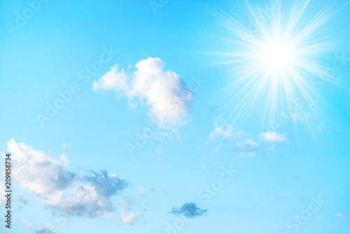 Sun on blue sky and white clouds as nature background