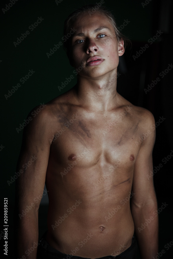 Young guy on a dark background.A strong athletic young man model.Beautiful lips and smile.Beautiful body. Young guy on a dark background.A strong athletic young man model.Beautiful lips and smile.Beautiful body.