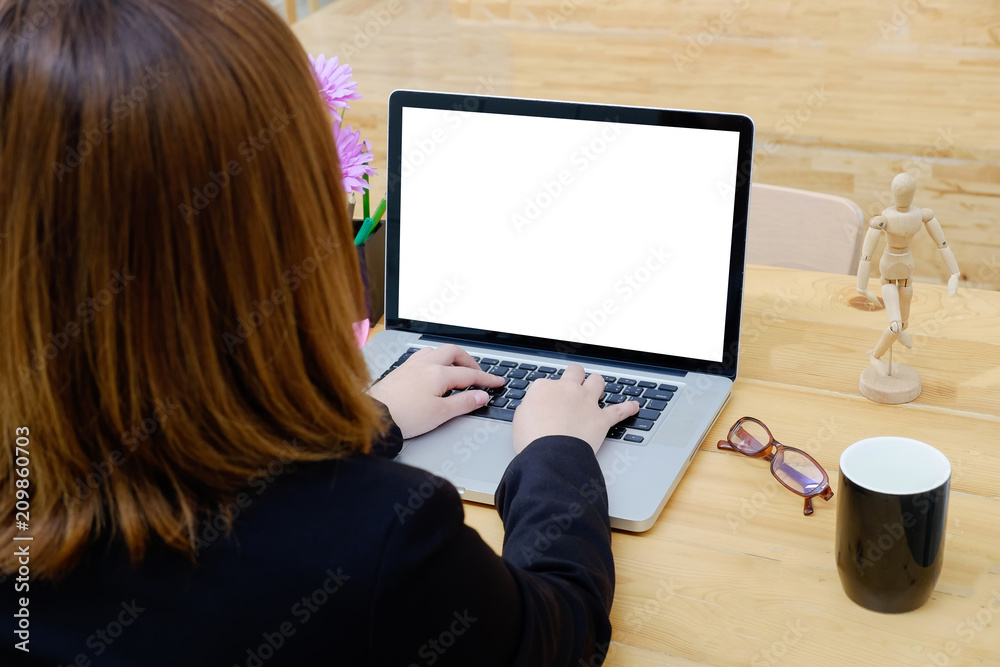 Businesswoman using mock up laptop computer with empty blank display.