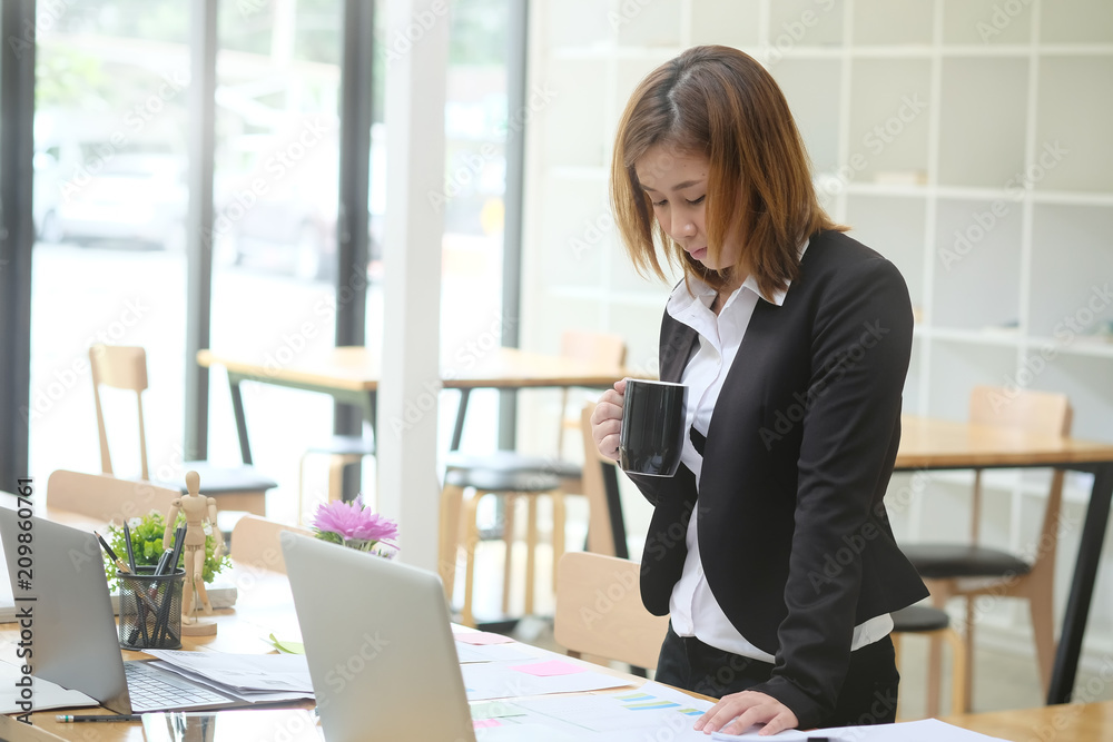 Asian woman working in office with laptop computer. Asian woman working in office with laptop computer.