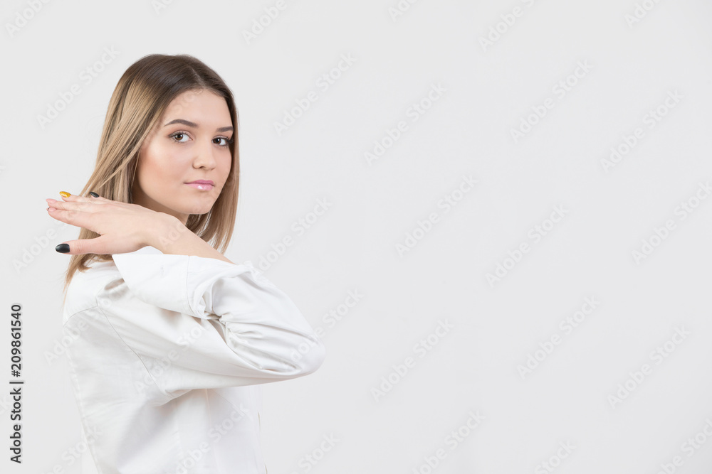 Beautiful young woman in a white shirt on a white background with a clean face Beautiful young woman in a white shirt on a white background with a clean face