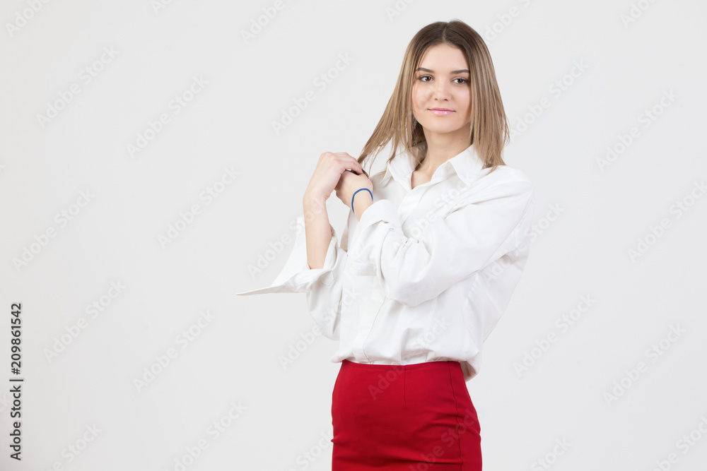 Beautiful young woman in a white shirt and a red skirt on a white background Beautiful young woman in a white shirt and a red skirt on a white background