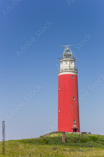 Red lighthouse on top of a dune on Texel island, The Netherlands
