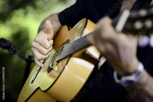 Photos closeup detail hand playing folk guitar outdoor summer festival
