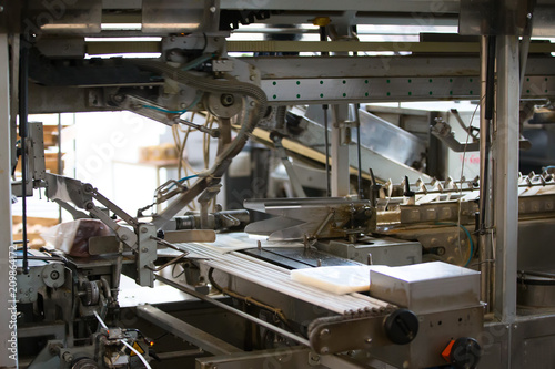 Industrial line for packaging of bakery products. Packing of bread at the factory.The machine for cutting and packing in a factory for the production of bread.