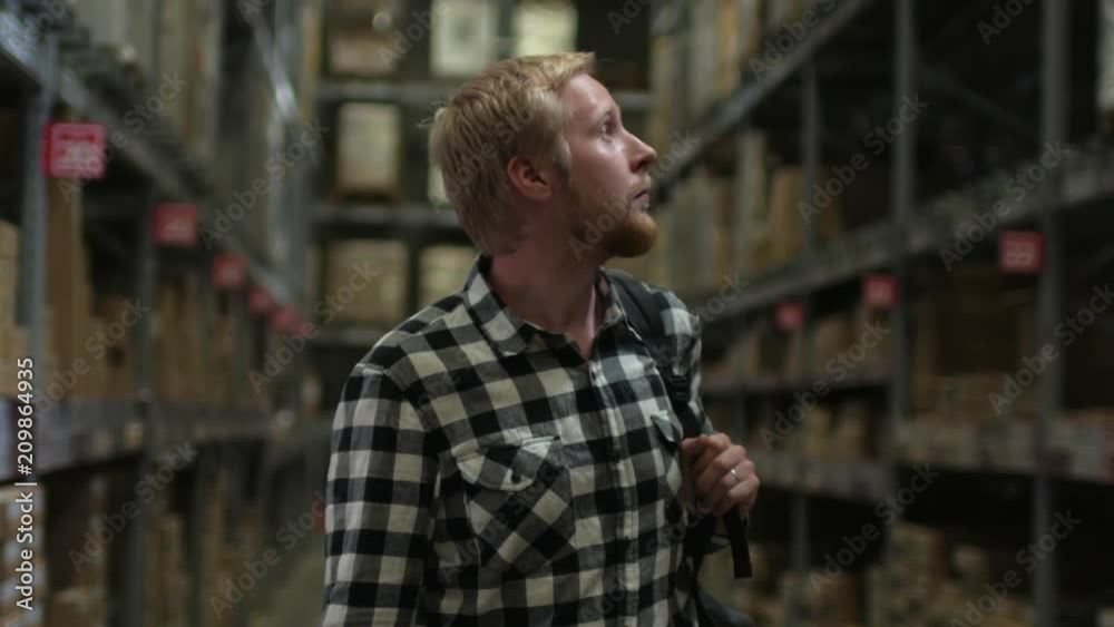 man in a warehouse store with boxes man in a warehouse store with boxes