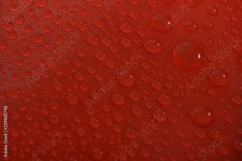 water drops on red background texture