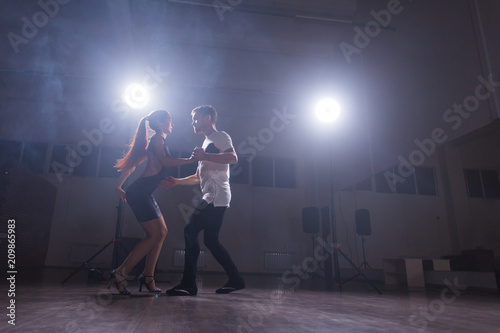 Active happy adults dancing bachata together in dance class © satura_