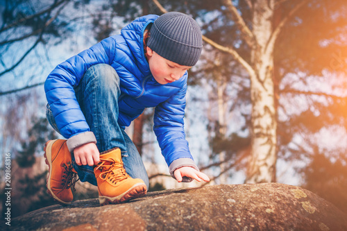 A young red-haired pathfinder looking for adventure making his way through the rocks