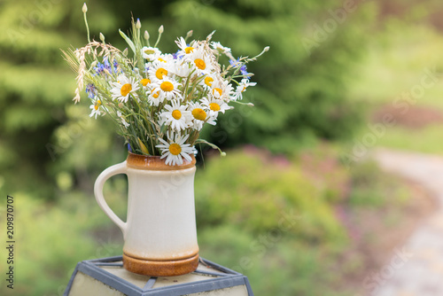 Fototapeta Naklejka Na Ścianę i Meble -  Midsummer in Latvia: celebration of Ligo in june decorating home with field flower bouquet