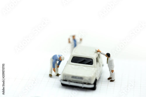 Miniature people : Professional painting car in a paint chamber during.