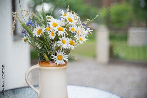 Fototapeta Naklejka Na Ścianę i Meble -  Midsummer in Latvia: celebration of Ligo in june decorating home with field flower bouquet
