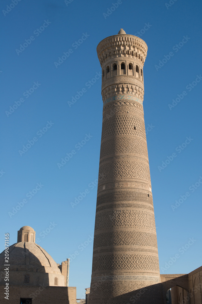 High oval tower of bricks, ancient Asian buildings. the details of the architecture of medieval Central Asia