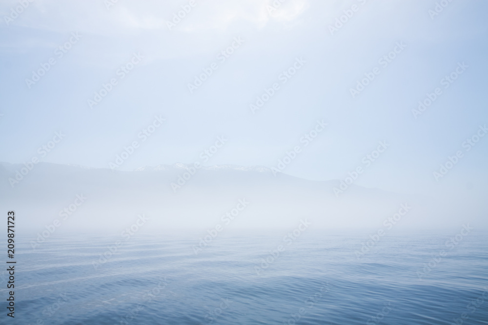 Foggy Teletskoye lake in clear weather