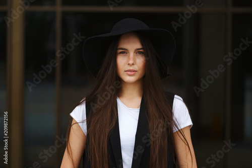 portrait of beautiful brunette with long hair © Aliaksei Lasevich